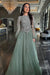 Elegant sage green Ashira long sleeve ball gown by Iyza Belaar, featuring a flowing long dress design.