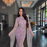 Iyza Belaar Basima long sleeve evening dress with floral sequins and embellishments, featuring a modest and elegant design.