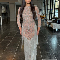Iyza Belaar Dalia long sleeve beaded sequin modest tassel gown, elegant evening dress with intricate beadwork and flowing fabric.