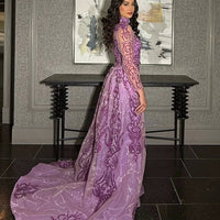 Iyza Belaar Deema long dress with high neckline, tulle fabric, and intricate embroidery, showcased in this elegant evening gown.