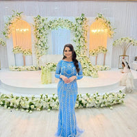 Iyza Belaar Fariza long sleeve modest evening dress with beaded embellishments, elegant and floor-length for formal occasions.