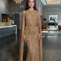 Iyza Belaar Nabilah embellished cape sleeve long dress, elegant evening gown with intricate details and flowing fabric.