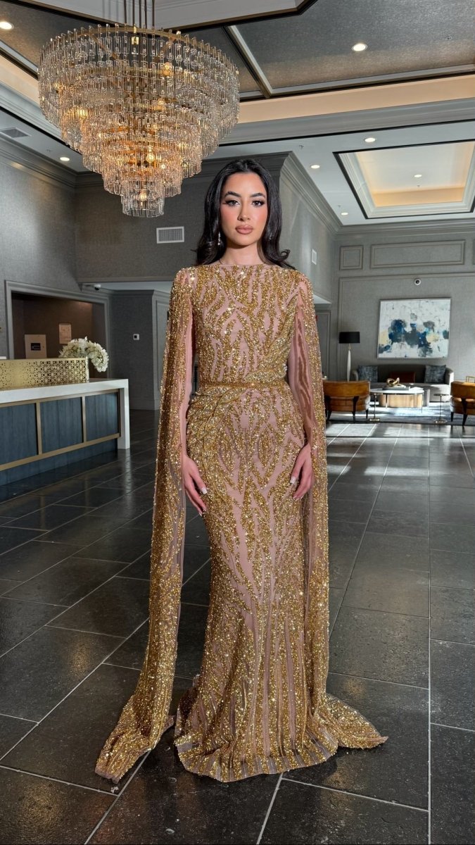 Iyza Belaar Nabilah embellished cape sleeve long dress, elegant evening gown with intricate details and flowing fabric.