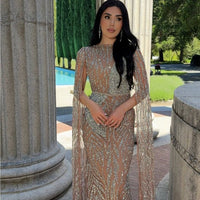 Iyza Belaar Nabilah embellished cape sleeve long dress with intricate embroidery and elegant design, perfect for formal occasions.