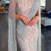 Iyza Belaar Nabilah embellished cape sleeve long dress with intricate details and elegant design, perfect for formal occasions.