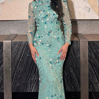 Iyza Belaar Raihana long sleeve high neck floral sequin evening dress with embellishments, modest and elegant for special occasions.
