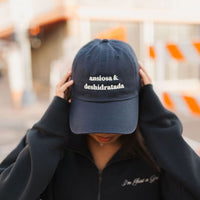 Navy blue Ansiosa & Deshidratada cap by JZD, featuring a curved brim and adjustable strap, shown on a plain background.