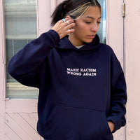 Navy sweatshirt by JZD with anti-racism message, casual fit, featuring bold text on front, made from soft fabric.