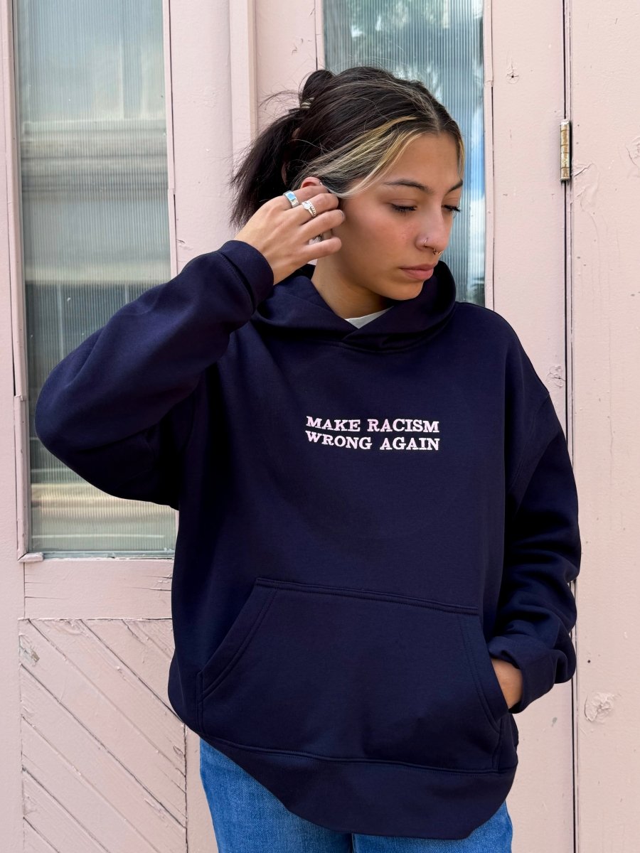 Navy sweatshirt by JZD with anti-racism message, casual fit, featuring bold text on front, made from soft fabric.