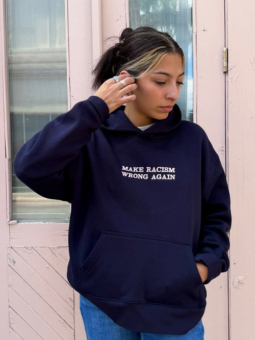 Navy sweatshirt by JZD with anti-racism message, casual fit, featuring bold text on front, made from soft fabric.