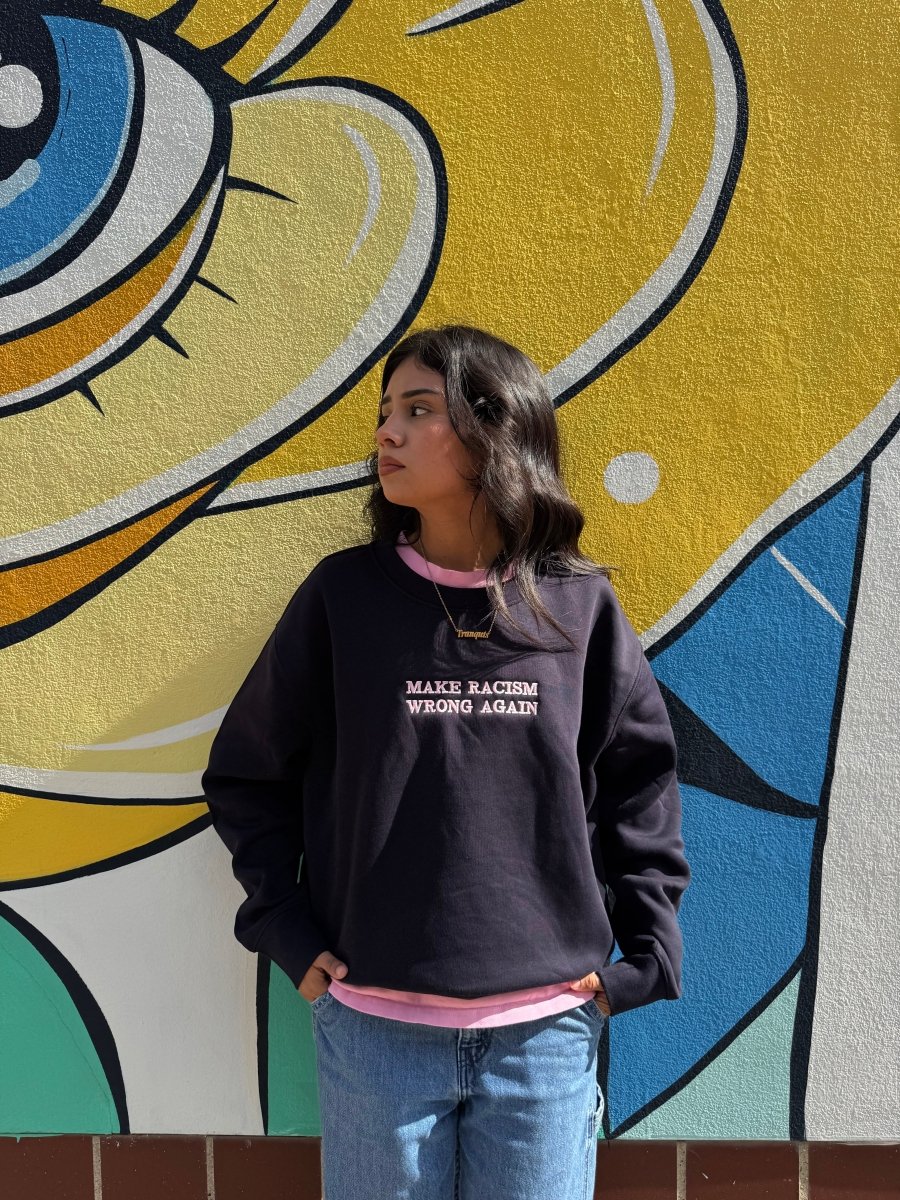Navy sweatshirt by JZD with anti-racism message, featuring a comfortable fit and printed text on the front.
