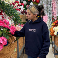 Navy JZD Anti-Racism sweatshirt with bold white text, crew neck style, made from soft fabric, casual and comfortable fit.