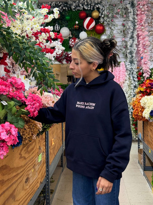 Navy JZD Anti-Racism sweatshirt with bold white text, crew neck style, made from soft fabric, casual and comfortable fit.