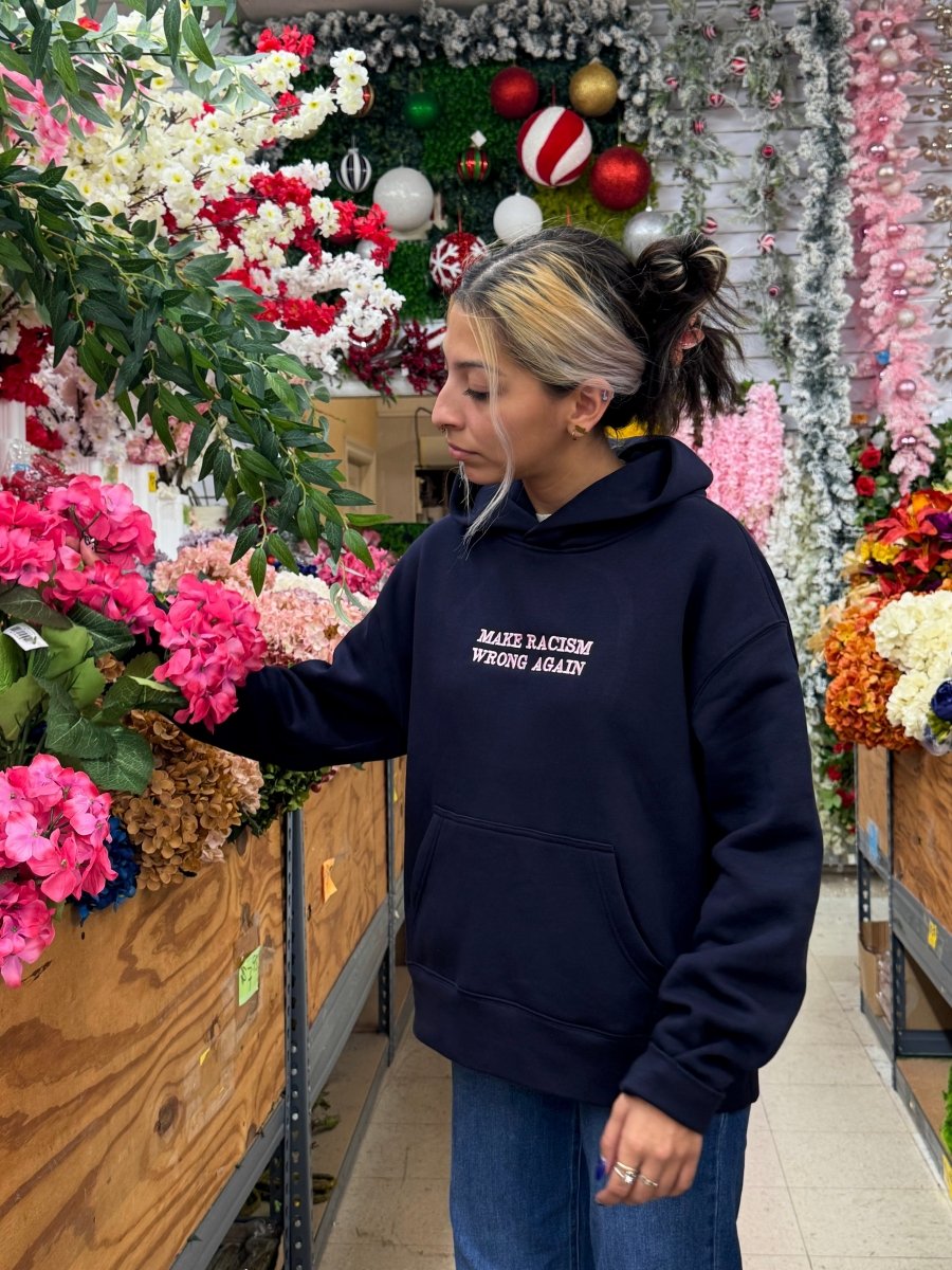 Navy JZD Anti-Racism sweatshirt with bold white text, crew neck style, made from soft fabric, casual and comfortable fit.