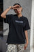Black Anti-Racism T-shirt by JZD featuring bold anti-racism message on the front, casual fit, and soft cotton fabric.