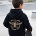 Baby and toddler black hoodie featuring winged mechanic design, recycled fabric, by LITTLE RAD THINGS, cozy outerwear for little adventurers.