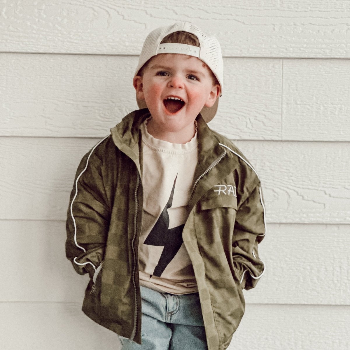 Little Rad Things Storm Rider waterproof jacket in army green, shown with front zipper and hood for outdoor protection.