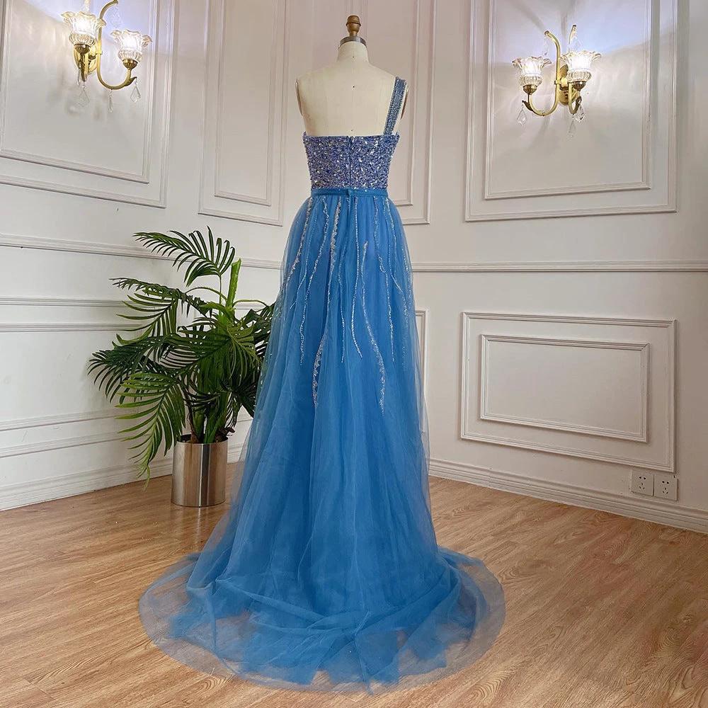 Blue handmade beaded split shoulder fishtail dress by MANDOTOS, showcasing intricate beadwork and elegant design.