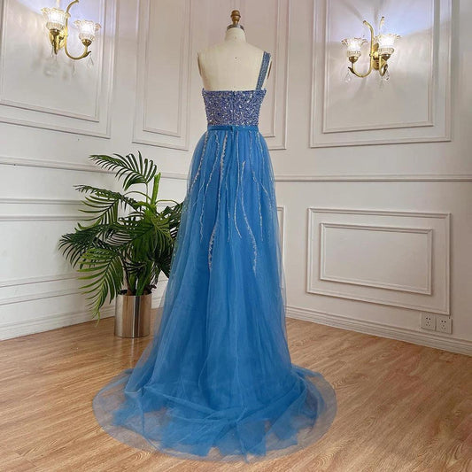 Blue handmade beaded split shoulder fishtail dress by MANDOTOS, showcasing intricate beadwork and elegant design.