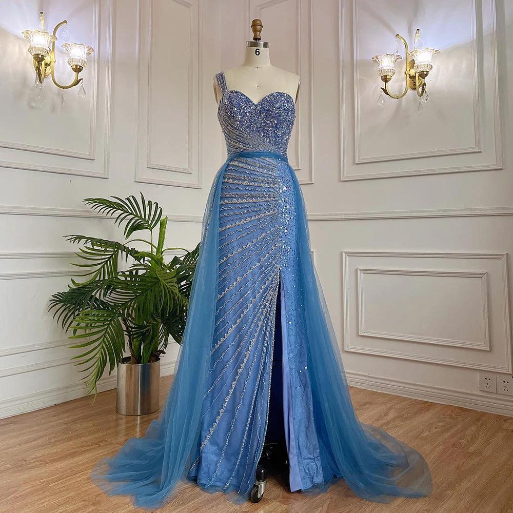 Blue handmade beaded split shoulder fishtail dress by MANDOTOS showing intricate beading and elegant fit on a model.