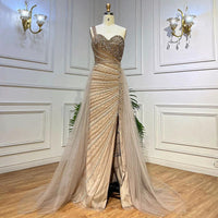 Blue handmade beaded split shoulder fishtail dress by MANDOTOS, showing intricate beadwork and flowing fabric with a split shoulder design.