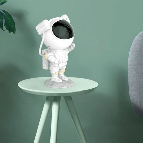 Mandotos astronaut galaxy starry sky projector nightlight illuminating a bedroom with USB power, creating a dreamy atmosphere.