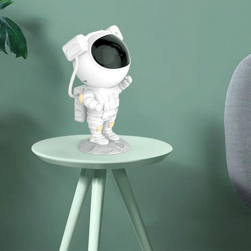 Mandotos astronaut galaxy starry sky projector nightlight illuminating a bedroom with USB power, creating a dreamy atmosphere.