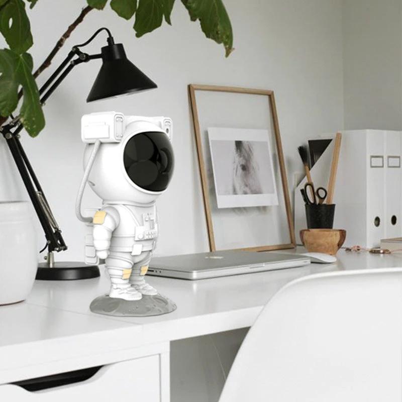Mandotos creative astronaut galaxy starry sky projector nightlight USB bedroom table lamp illuminating a starry sky scene.