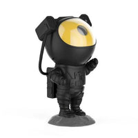 Mandotos creative astronaut galaxy starry sky projector nightlight USB bedroom table lamp displaying cosmic star patterns in a bedroom setting.