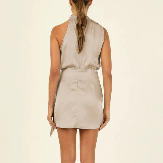 Mandotos elegant halter neck sleeveless short dress with waist tie, perfect for evening parties, worn by a woman.