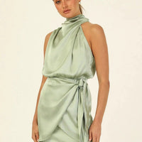 Elegant MANDOTOS halter neck sleeveless short dress with waist tie, perfect for evening parties and stylish women’s fashion.