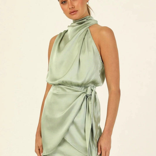 Elegant MANDOTOS halter neck sleeveless short dress with waist tie, perfect for evening parties and stylish women’s fashion.