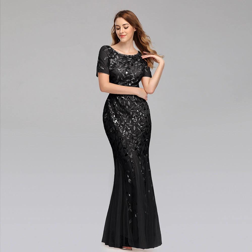 Elegant black evening dress by MANDOTOS featuring a floor-length design and subtle satin finish.
