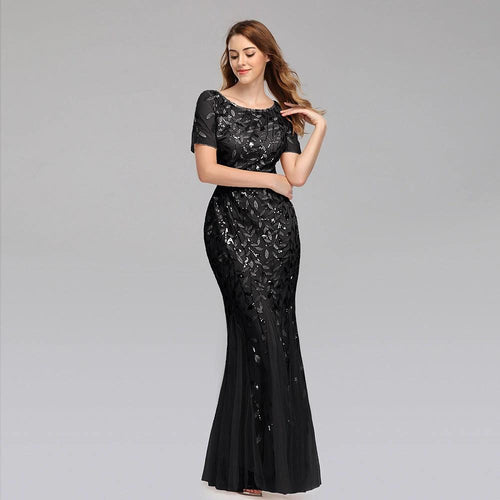 Elegant black evening dress by MANDOTOS featuring a floor-length design and subtle satin finish.