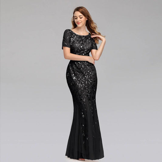 Elegant black evening dress by MANDOTOS featuring a fitted bodice and flowing skirt, perfect for formal occasions.