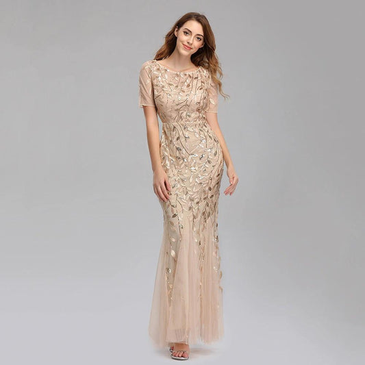 Elegant black evening dress by MANDOTOS featuring a fitted silhouette and off-shoulder design, perfect for formal occasions.