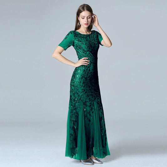 Elegant MANDOTOS evening dress in black with a flowing silhouette and sleeveless design, perfect for formal occasions.