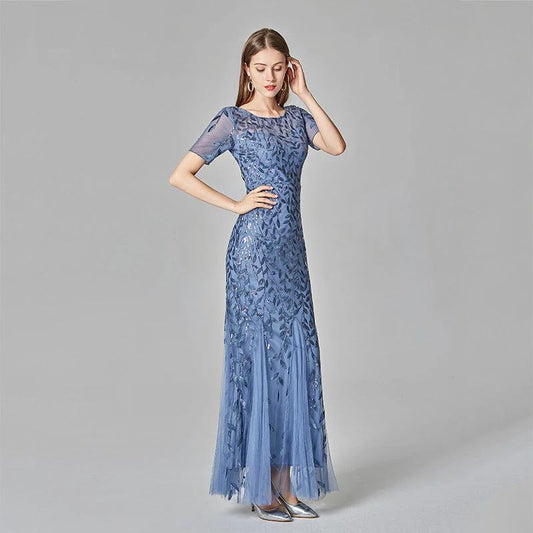 Elegant black evening dress by MANDOTOS, featuring a flowing silhouette and stylish design for formal occasions.