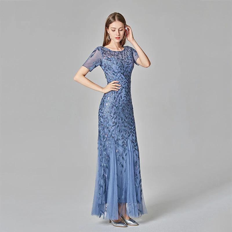 Elegant black evening dress by MANDOTOS, featuring a flowing silhouette and stylish design for formal occasions.