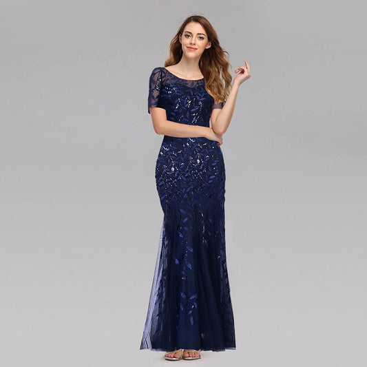 Elegant black evening dress by MANDOTOS featuring a flowing design and stylish neckline, perfect for formal occasions.
