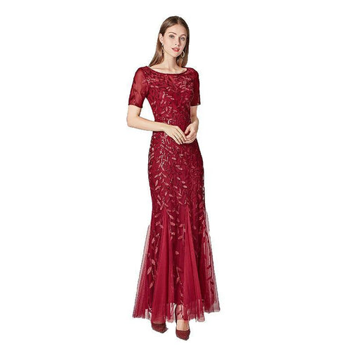Elegant black evening dress by MANDOTOS featuring a flowing silhouette and stylish neckline, perfect for formal occasions.