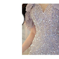 Elegant women's halter evening gown by MANDOTOS featuring a classic French style and flowing fabric.