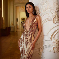 Female model wearing a creative V-neck heavy industry dress by MANDOTOS, showcasing a modern, stylish design.