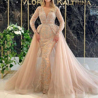 Simple French style long-sleeved wedding dress by MANDOTOS with elegant design and flowing fabric, shown on a model.