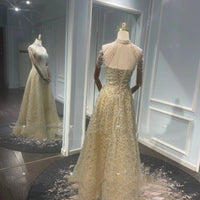Mandotos luxury toast-colored evening dress with golden neck hanging light embellishments, elegant and stylish for special occasions.