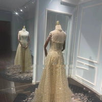 Mandotos luxury toast evening dress with a golden neck hanging light design, elegant for formal occasions.