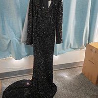 Grey long sleeve sequin evening dress by MANDOTOS, featuring a fitted silhouette and elegant design for formal occasions.