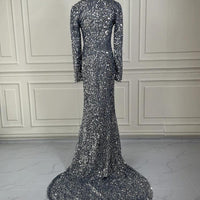 Grey long sleeve sequin evening dress by MANDOTOS, featuring a fitted silhouette and elegant design for formal occasions.