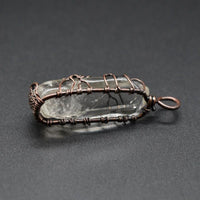 Mandotos stone crystal pillar Tree of Life pendant necklace showcasing intricate design and natural gemstone details.