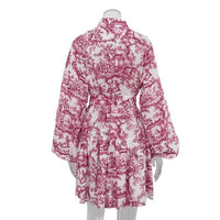 Mandotos ink print long sleeve short dress with puffy sleeves, lapel collar, tie waist, and A-line silhouette.